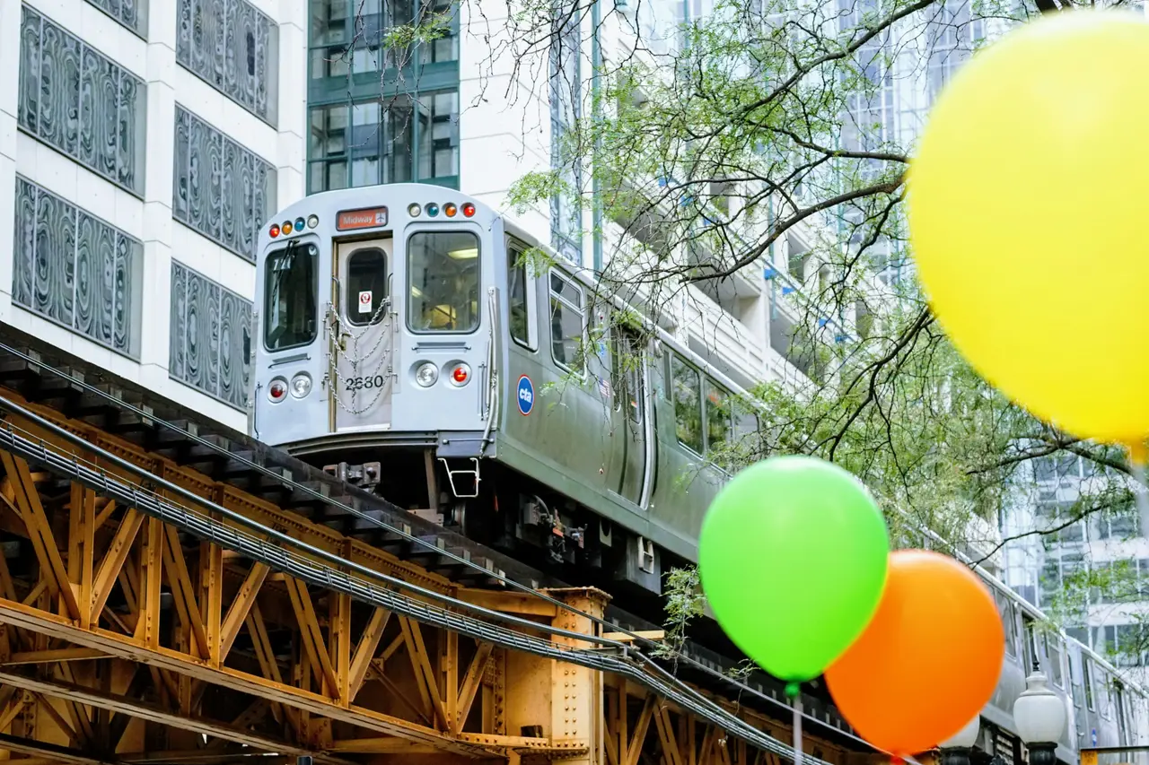 An elevated metro train crossing a steel viaduct