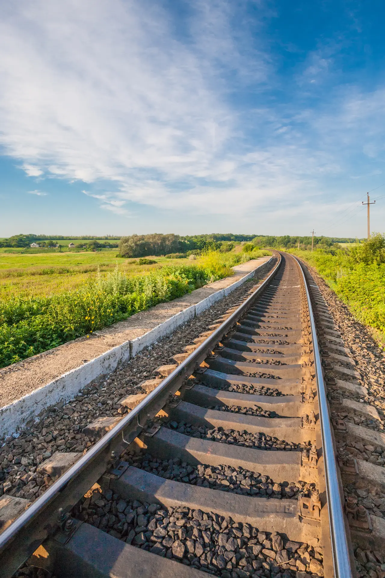 Railway track running through open countryside